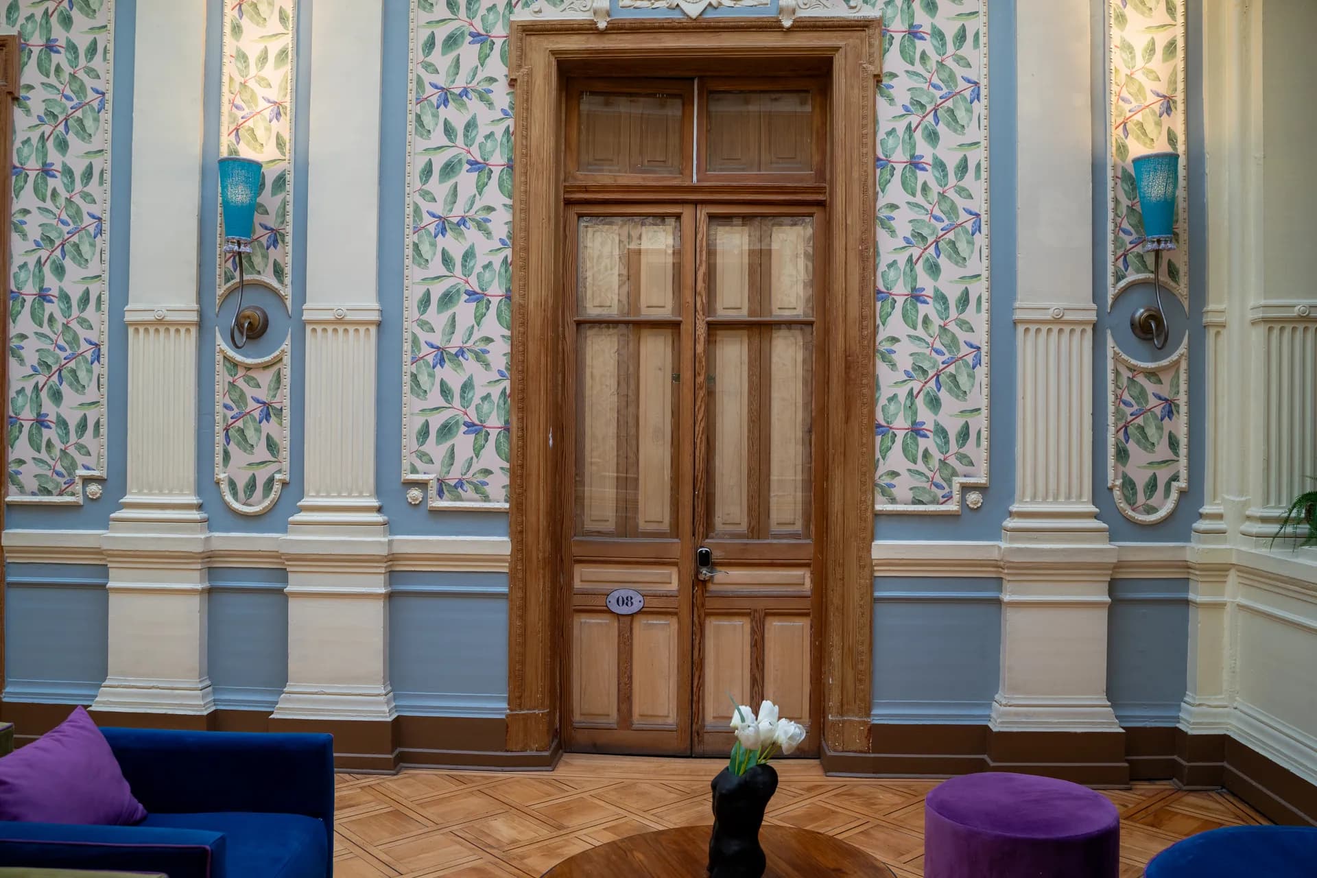 Happy Hostel grand entrance hall with original parquet floors, decorative moldings and heritage architectural details in Santiago Centro