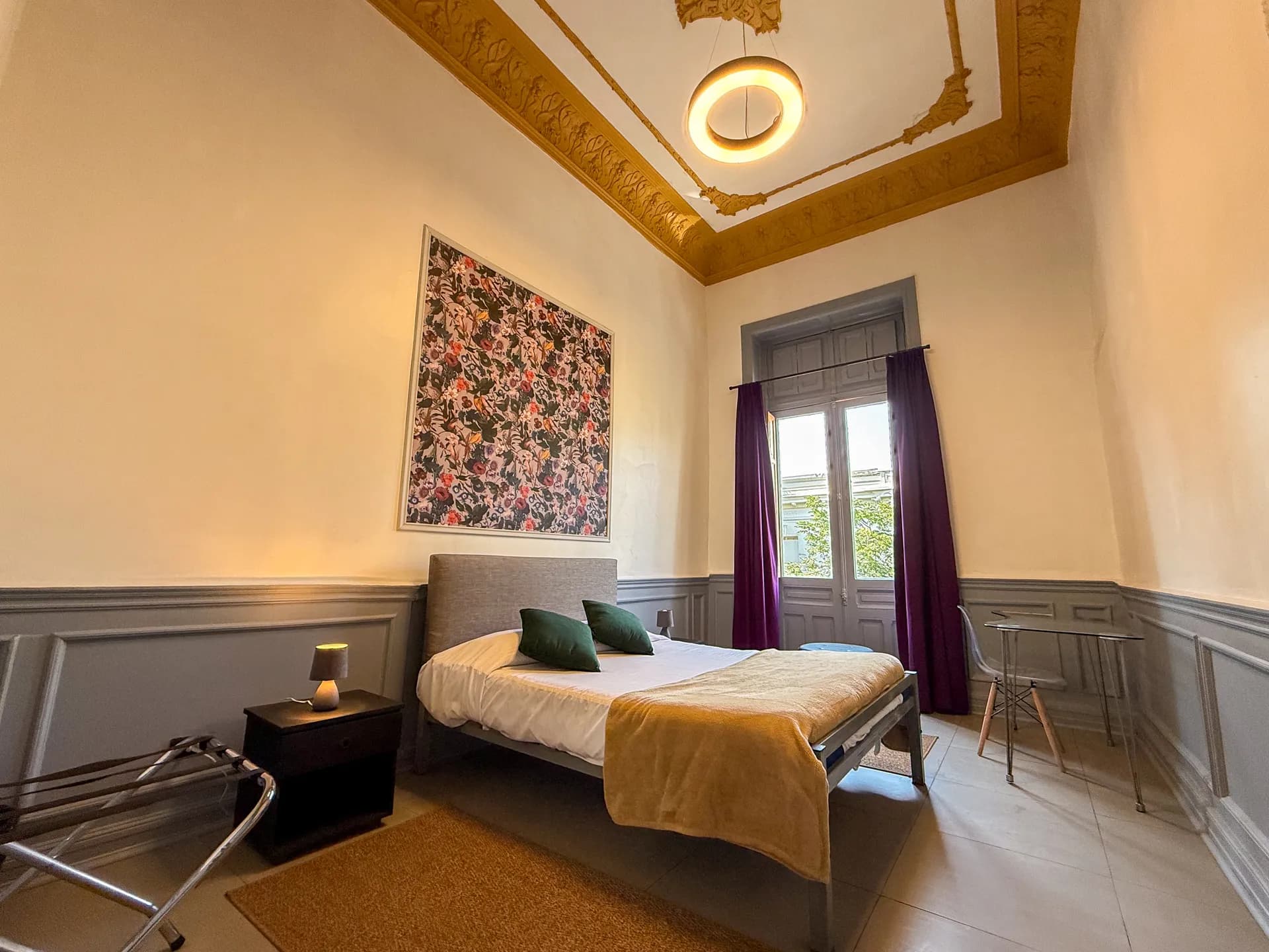 Clean and comfortable standard private room at Happy Hostel Santiago with double bed and wooden floors