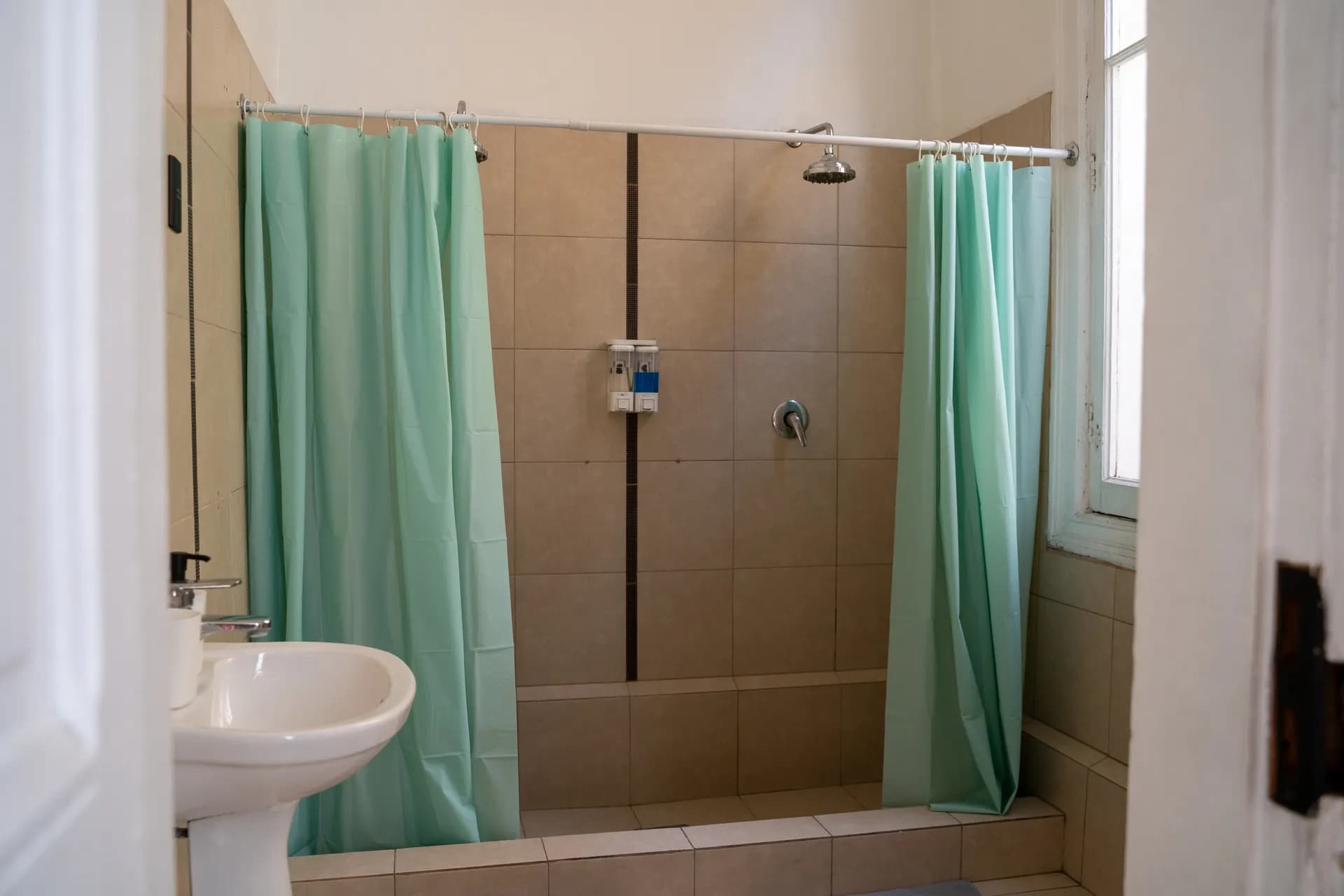 Deluxe twin room with two single beds at Happy Hostel Santiago with tropical botanical wallpaper and modern LED lighting